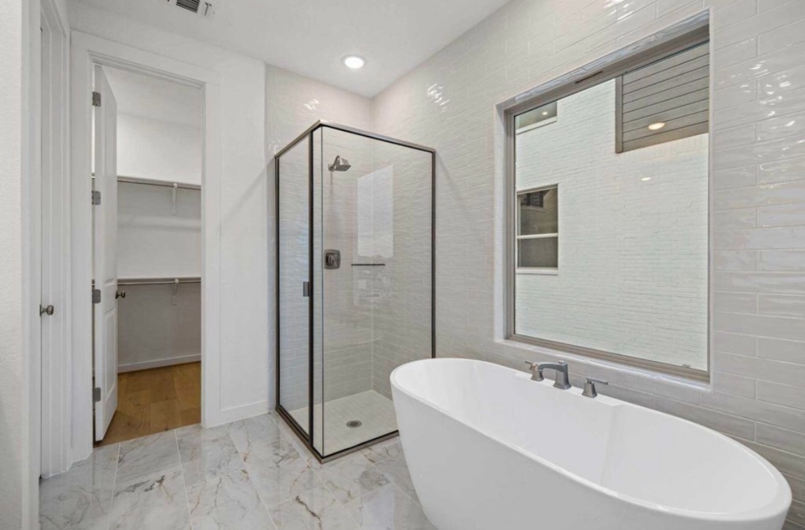 1116 Addison Lane Georgetown, TX 78628 - Photo 9 of 17 a spacious bathroom with a tub shower and sink