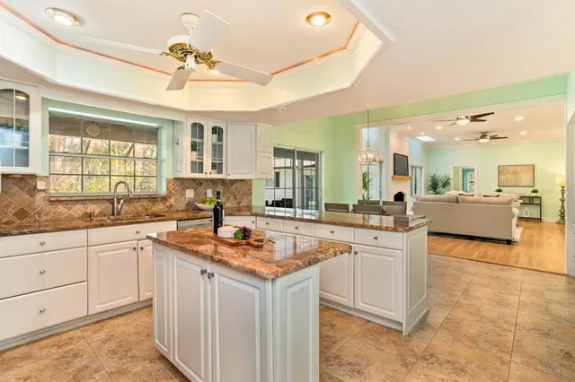 a kitchen with granite countertop a table and chairs in it