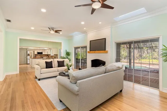 a living room with furniture a fireplace and a flat screen tv