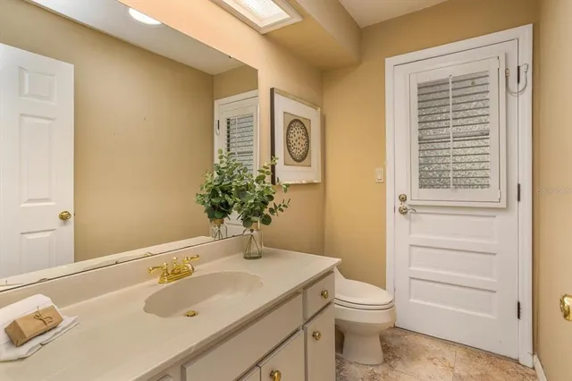 a view of a kitchen with refrigerator stove and wooden cabinets