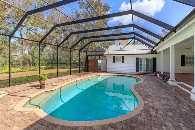 a view of backyard with wooden fence