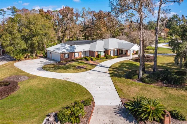 an aerial view of a house with a yard and garden