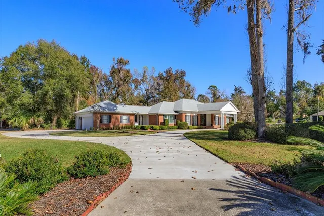 a view of a house with backyard and porch