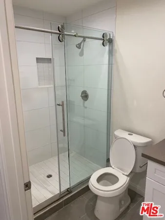 a bathroom with a toilet and a shower