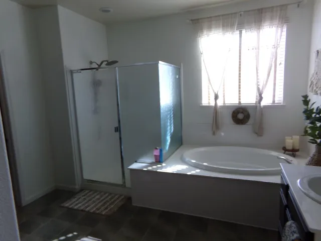 a bath tub sitting in a bathroom next to a window