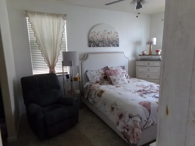 a bathroom with a granite countertop sink a mirror and a shower