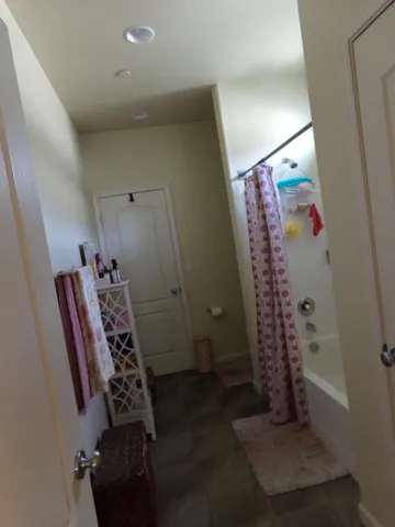 a bedroom with a bed and a potted plant