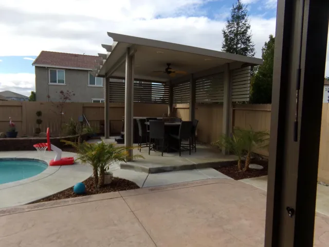 a backyard of a house with table and chairs