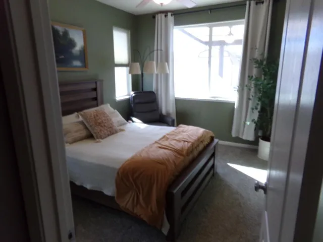 a bedroom with a bed and a window