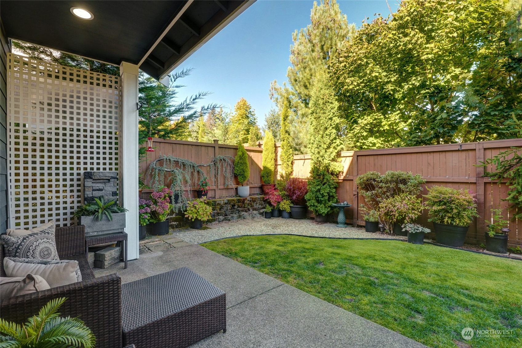 3533 198th Street Southeast Bothell, WA 98012 - Photo 23 of 27 a view of a patio with table and chairs potted plants and large tree