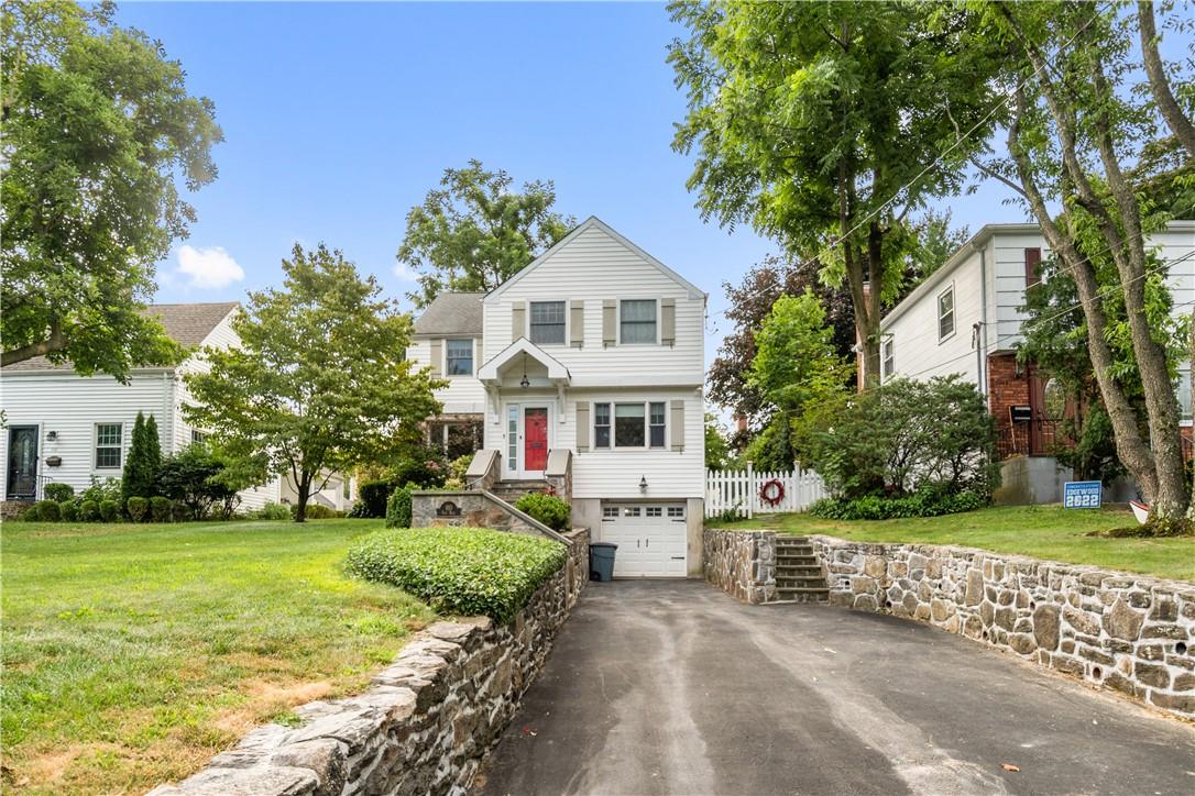 910 Post Road Scarsdale, NY 10583 - Photo 1 of 1 a white house with a big yard and large trees
