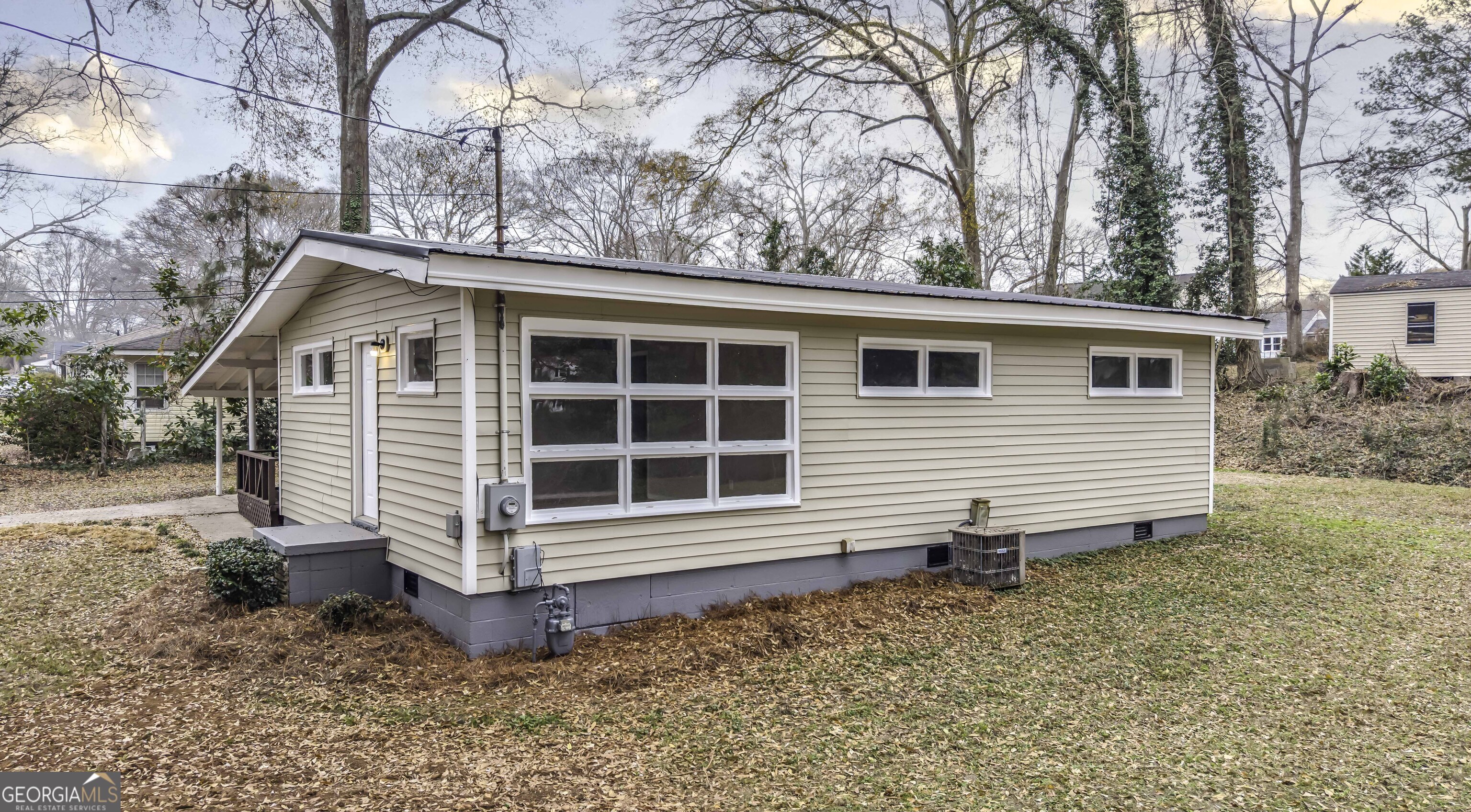 a view of a house with a yard and wooden fence