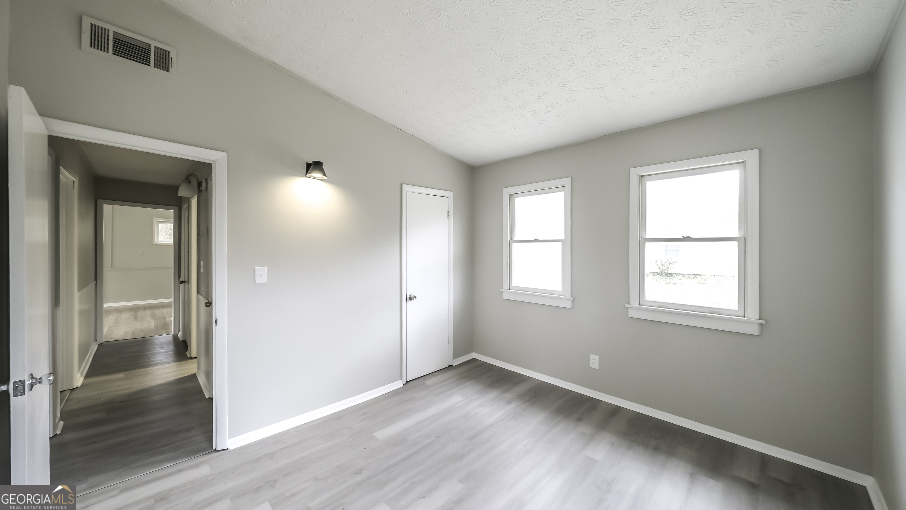 208 Richards Street Carrollton, GA 30117 - Photo 17 of 42 an empty room with wooden floor and windows