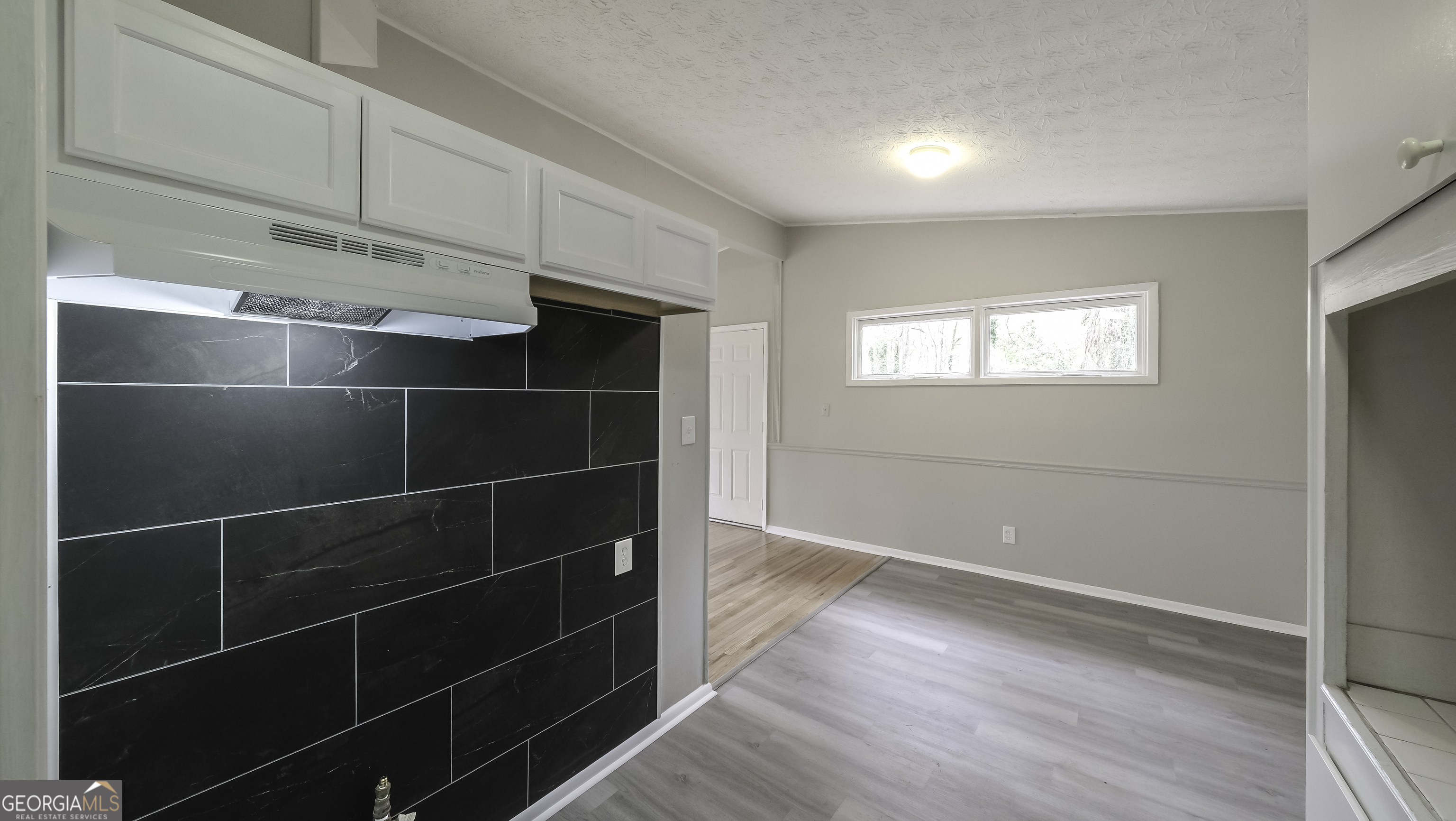 208 Richards Street Carrollton, GA 30117 - Photo 24 of 42 a view of a room with wooden floor and windows