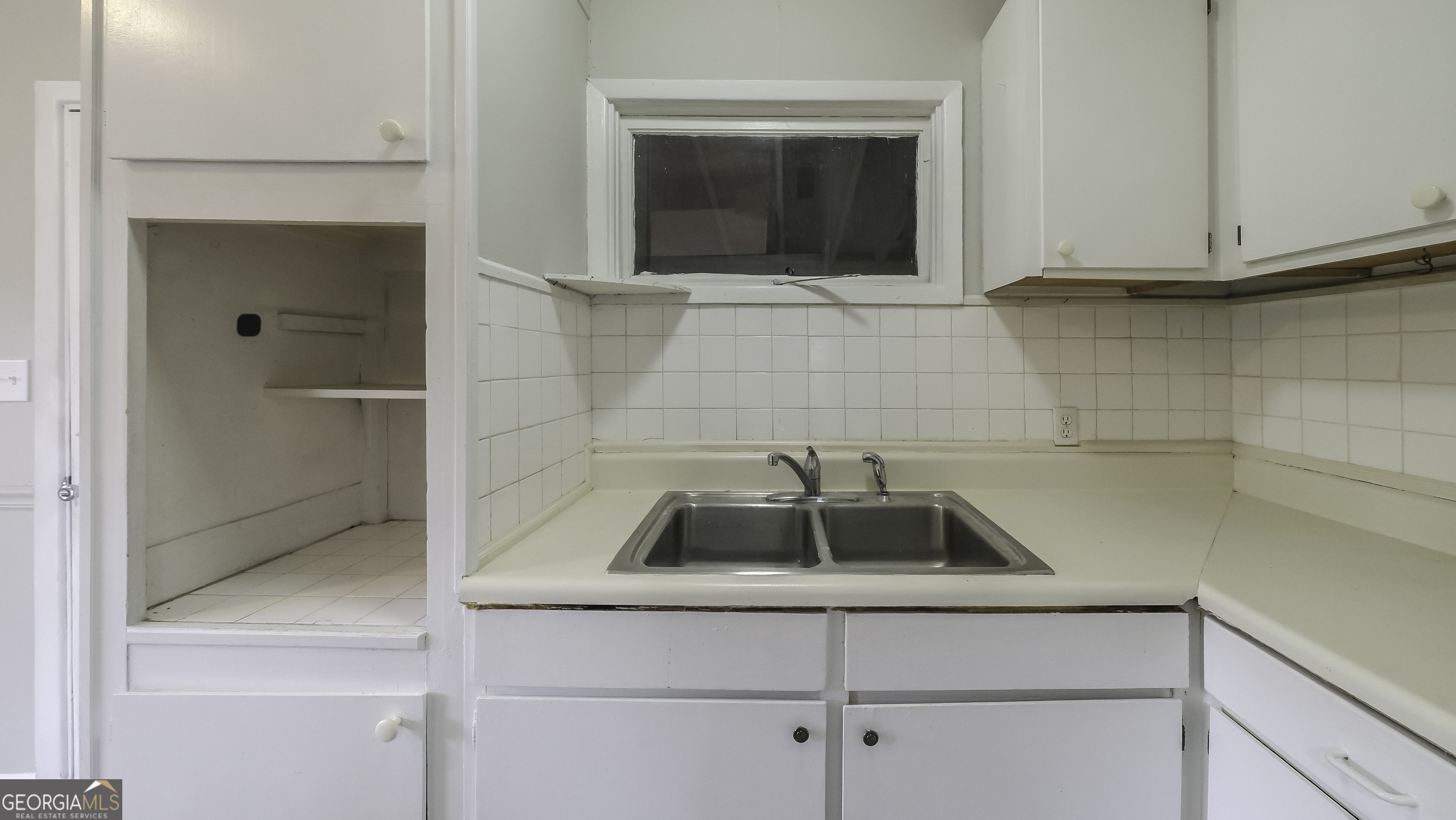 208 Richards Street Carrollton, GA 30117 - Photo 31 of 42 a kitchen with a sink and cabinets
