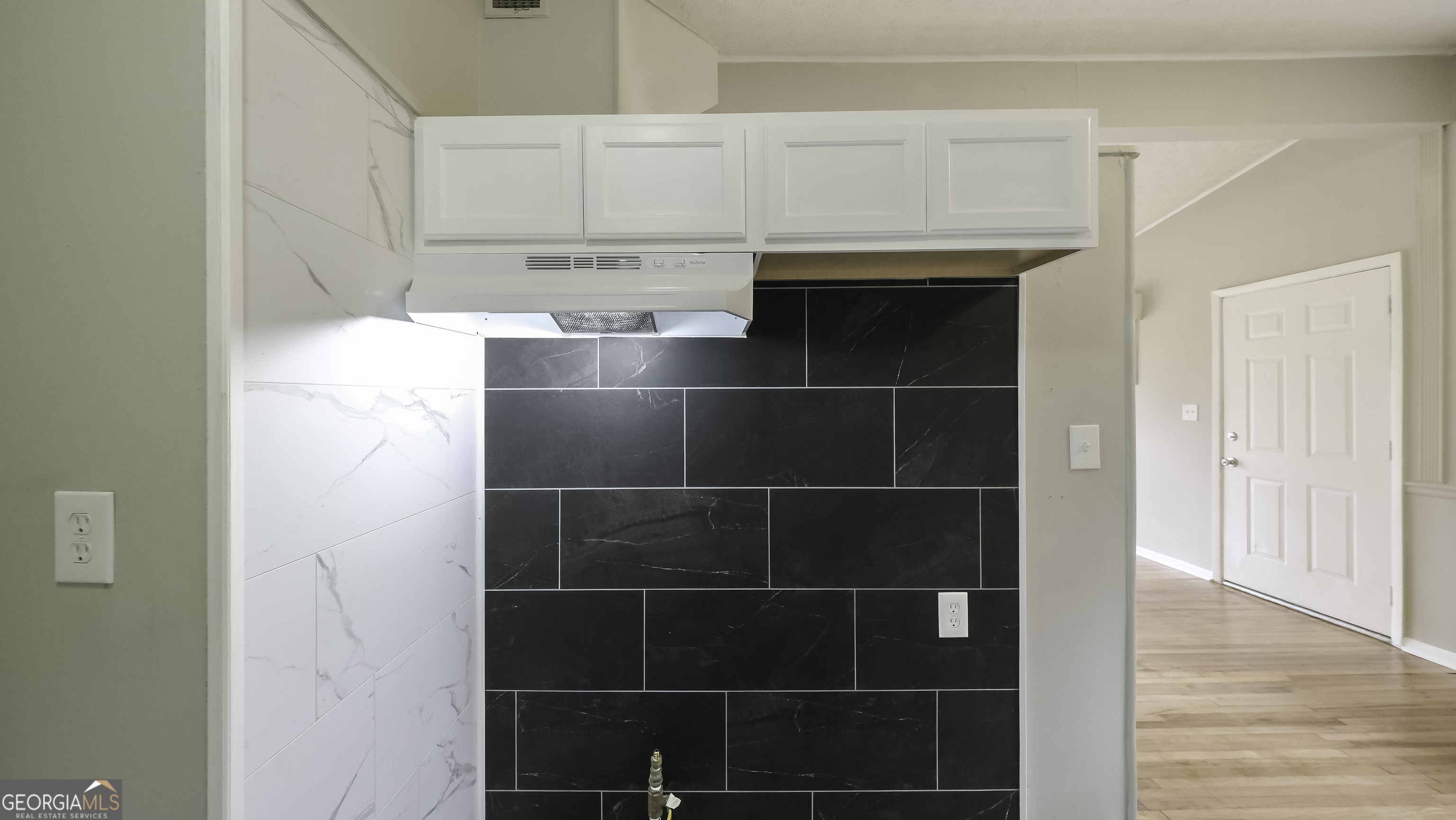 208 Richards Street Carrollton, GA 30117 - Photo 32 of 42 a kitchen with a sink and cabinets