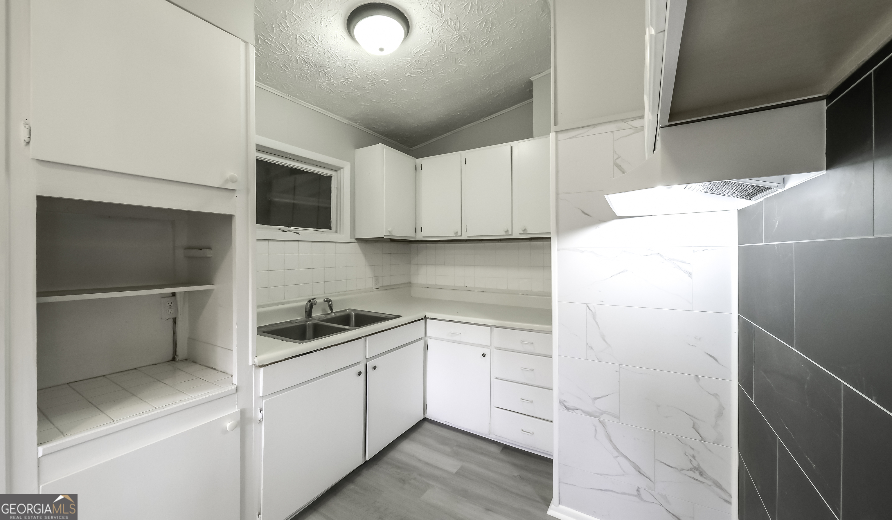 208 Richards Street Carrollton, GA 30117 - Photo 33 of 42 a kitchen with a sink and refrigerator