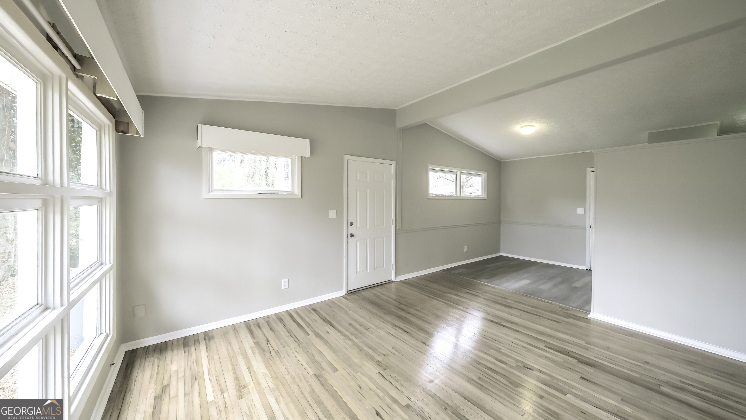 208 Richards Street Carrollton, GA 30117 - Photo 35 of 42 a view of empty room with window and wooden floor