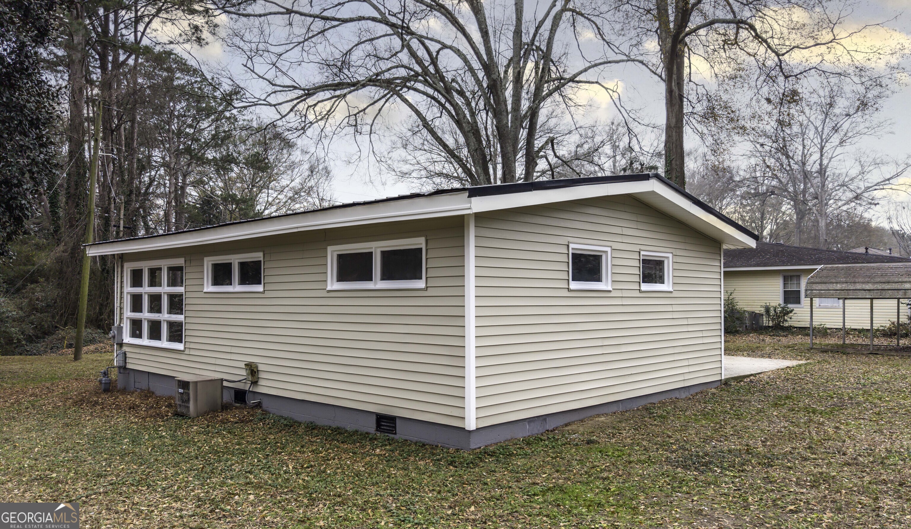 208 Richards Street Carrollton, GA 30117 - Photo 5 of 42 a view of a house with a yard and large tree