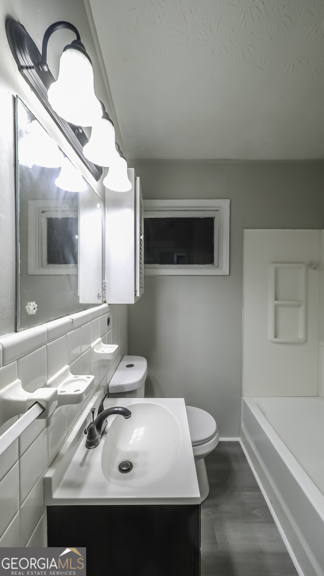 208 Richards Street Carrollton, GA 30117 - Photo 9 of 42 a bathroom with a sink and a mirror