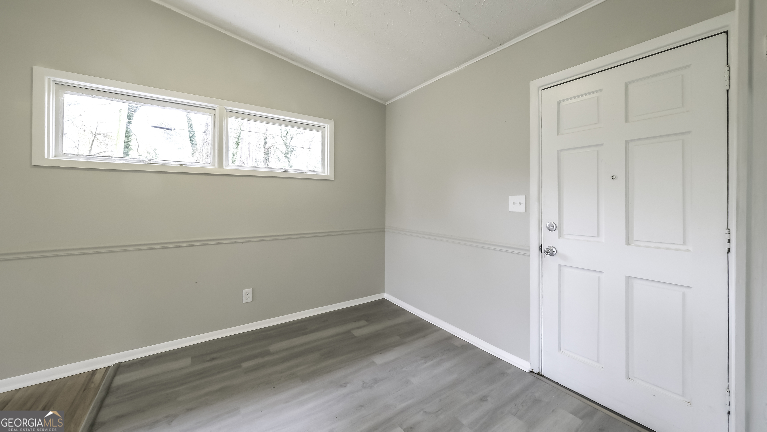 208 Richards Street Carrollton, GA 30117 - Photo 10 of 42 an empty room with wooden floor and windows