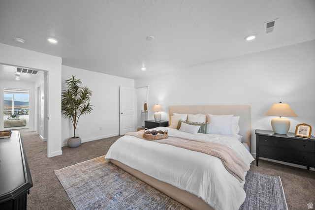 2123 Wolverine Way, Unit 2437 Washington, UT 84780 - Photo 35 of 40 Carpeted bedroom featuring white walls, recessed lighting, and a white door leading to an adjacent area with a window