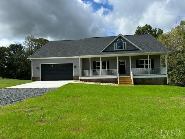 a front view of a house with a yard and green space