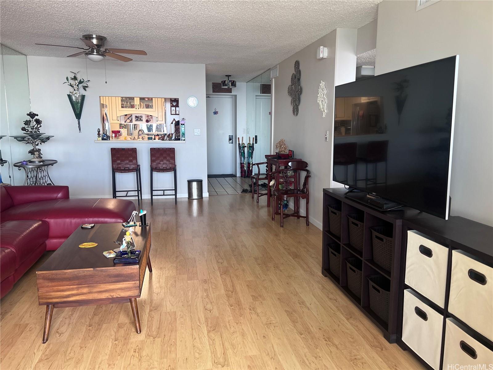 1650 Ala Moana Boulevard, Unit 3107 Honolulu, HI 96815 - Photo 17 of 22 a living room with furniture and a flat screen tv
