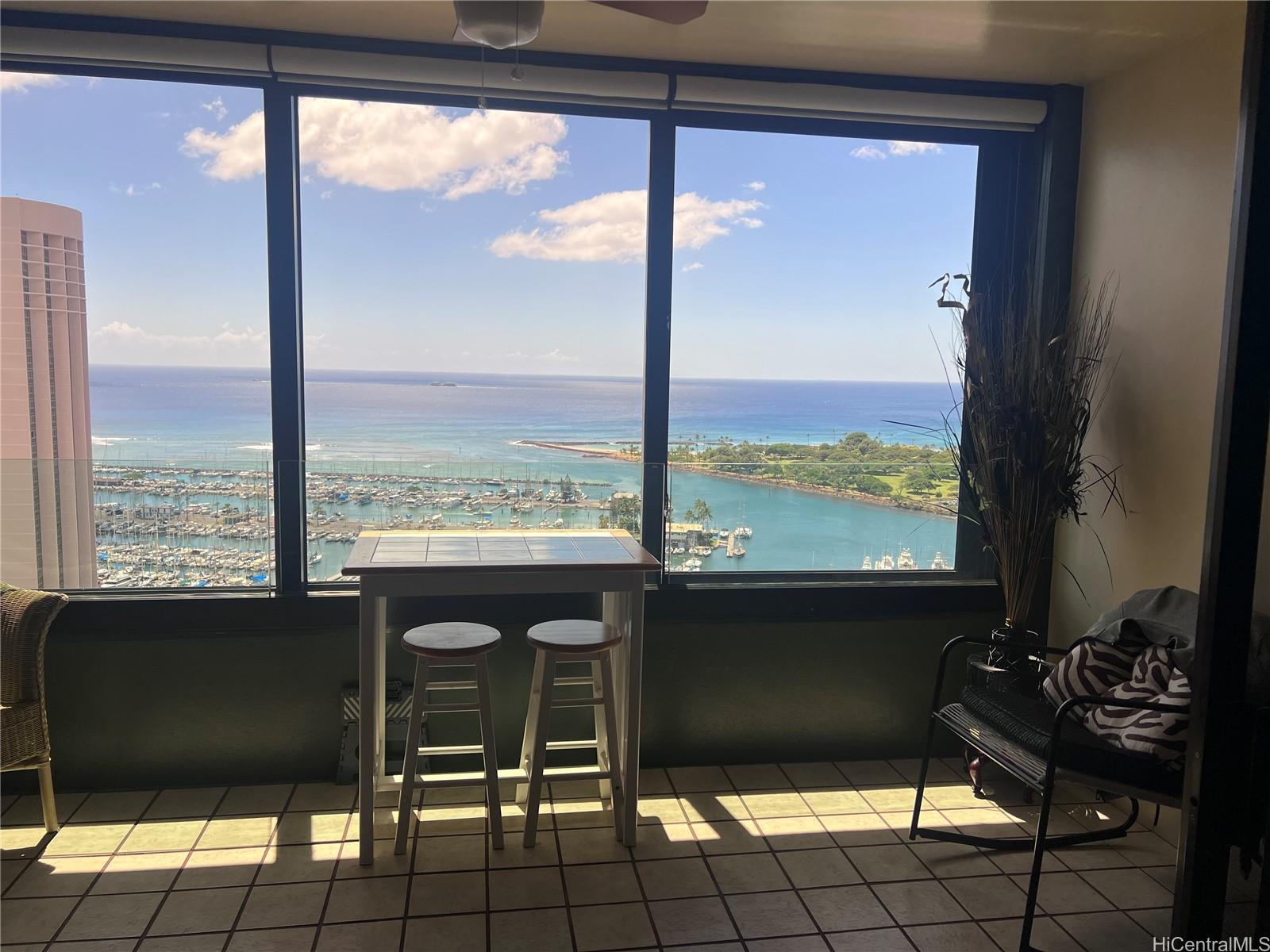 1650 Ala Moana Boulevard, Unit 3107 Honolulu, HI 96815 - Photo 18 of 22 a view of a balcony with chairs and a table