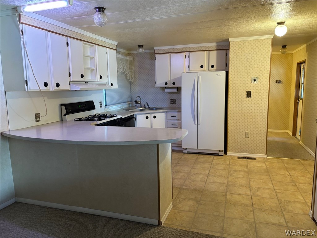 3565 Ehrenberg Road Golden Valley, AZ 86413 - Photo 24 of 63 a kitchen with stainless steel appliances a stove a refrigerator a sink a cabinets and island
