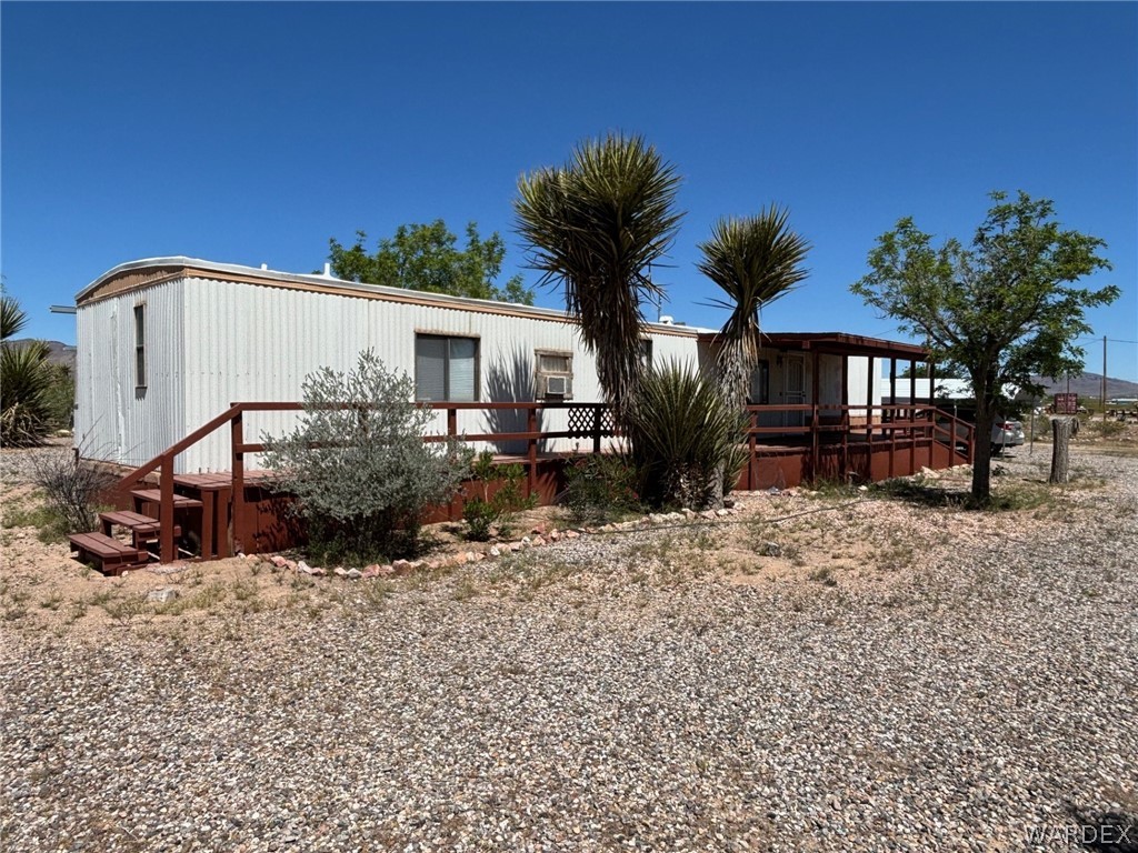 3565 Ehrenberg Road Golden Valley, AZ 86413 - Photo 9 of 63 a front view of a house with a yard covered with furniture
