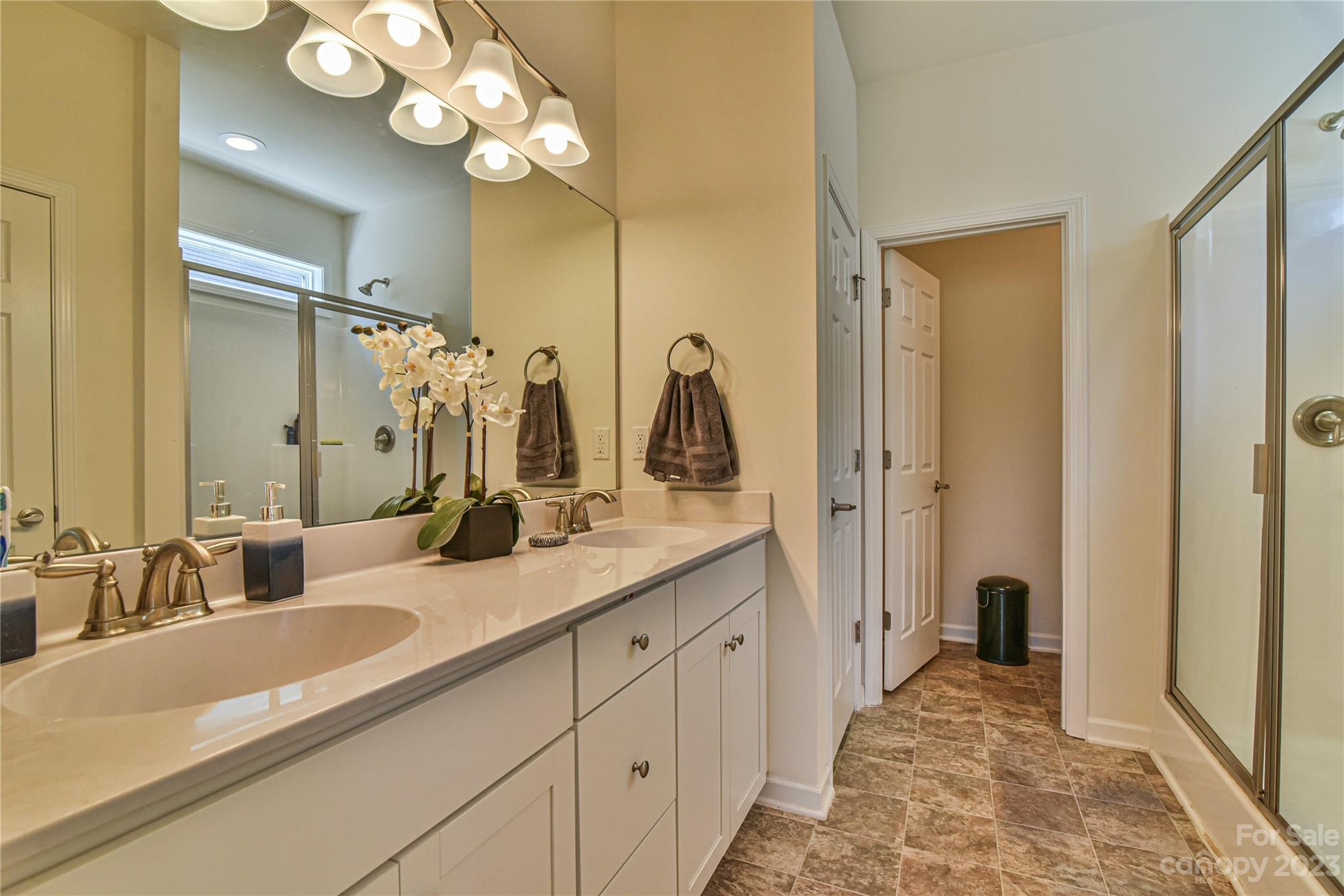 18 Yadkin Road Fletcher, NC 28732 - Photo 16 of 25 a bathroom with a double vanity sink mirror and shower