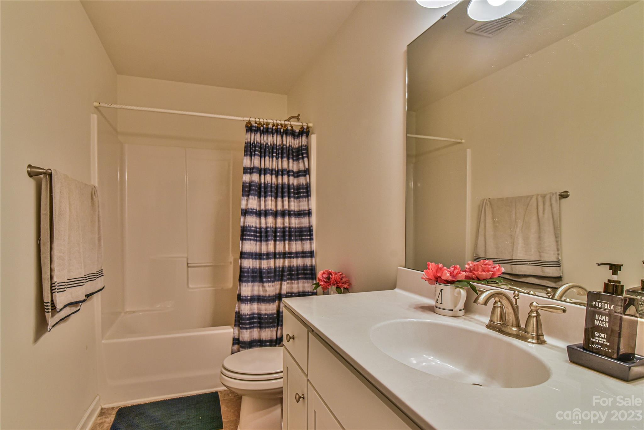 18 Yadkin Road Fletcher, NC 28732 - Photo 20 of 25 a bathroom with a sink toilet and shower