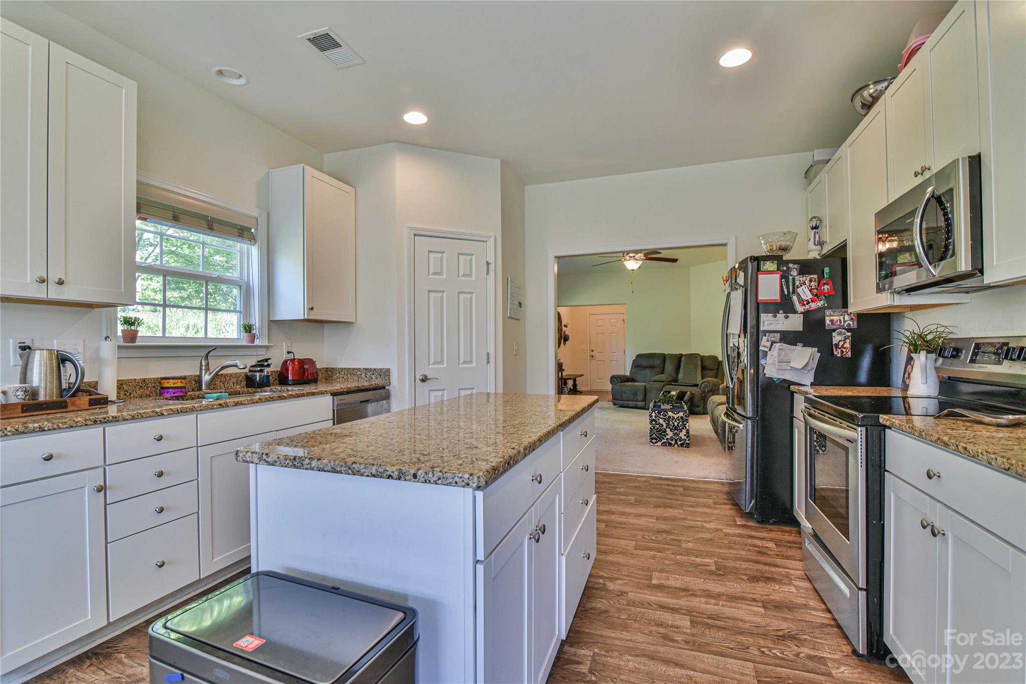 18 Yadkin Road Fletcher, NC 28732 - Photo 4 of 25 a kitchen with sink stove and cabinets