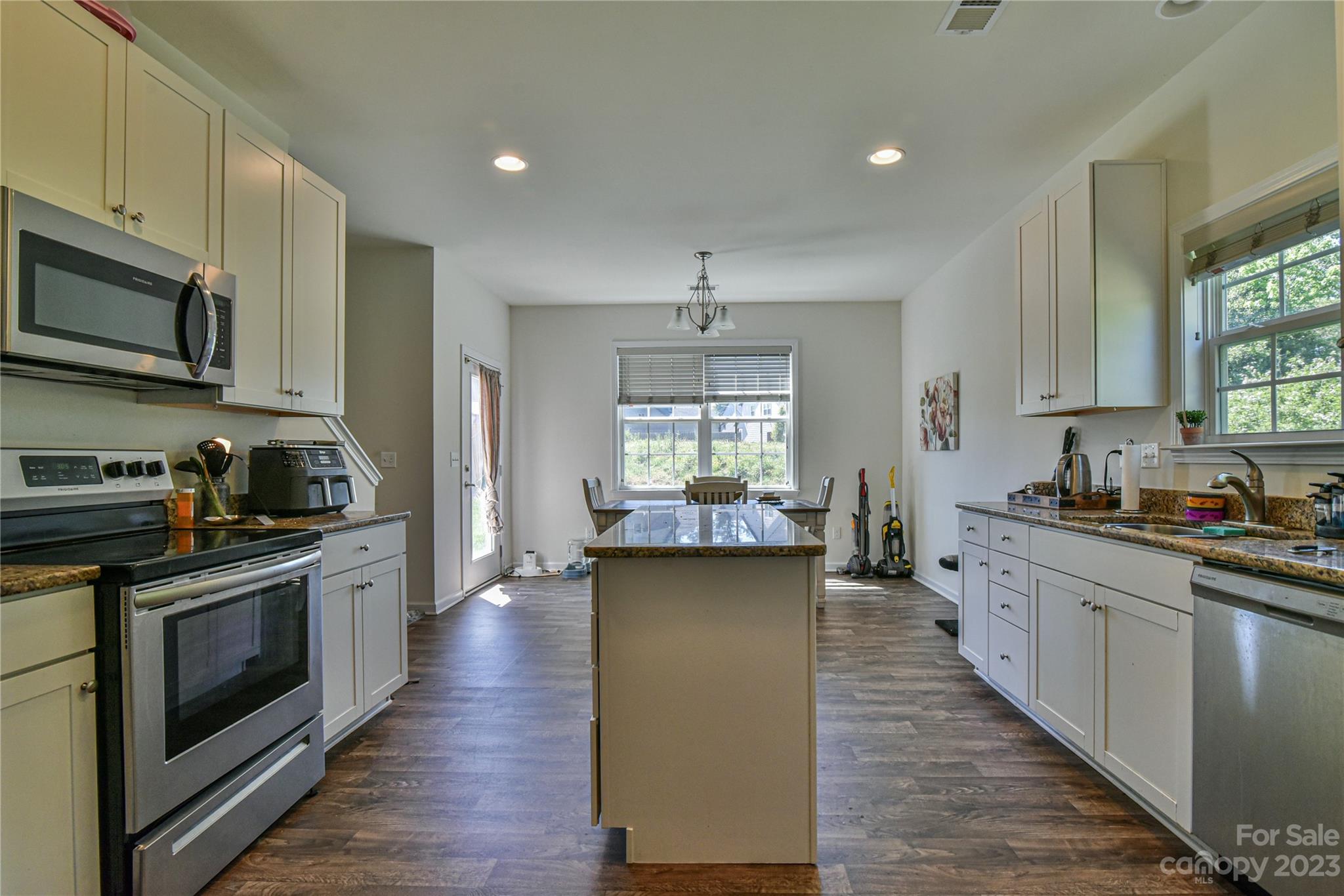 18 Yadkin Road Fletcher, NC 28732 - Photo 6 of 25 a kitchen with stainless steel appliances a stove sink microwave and cabinets