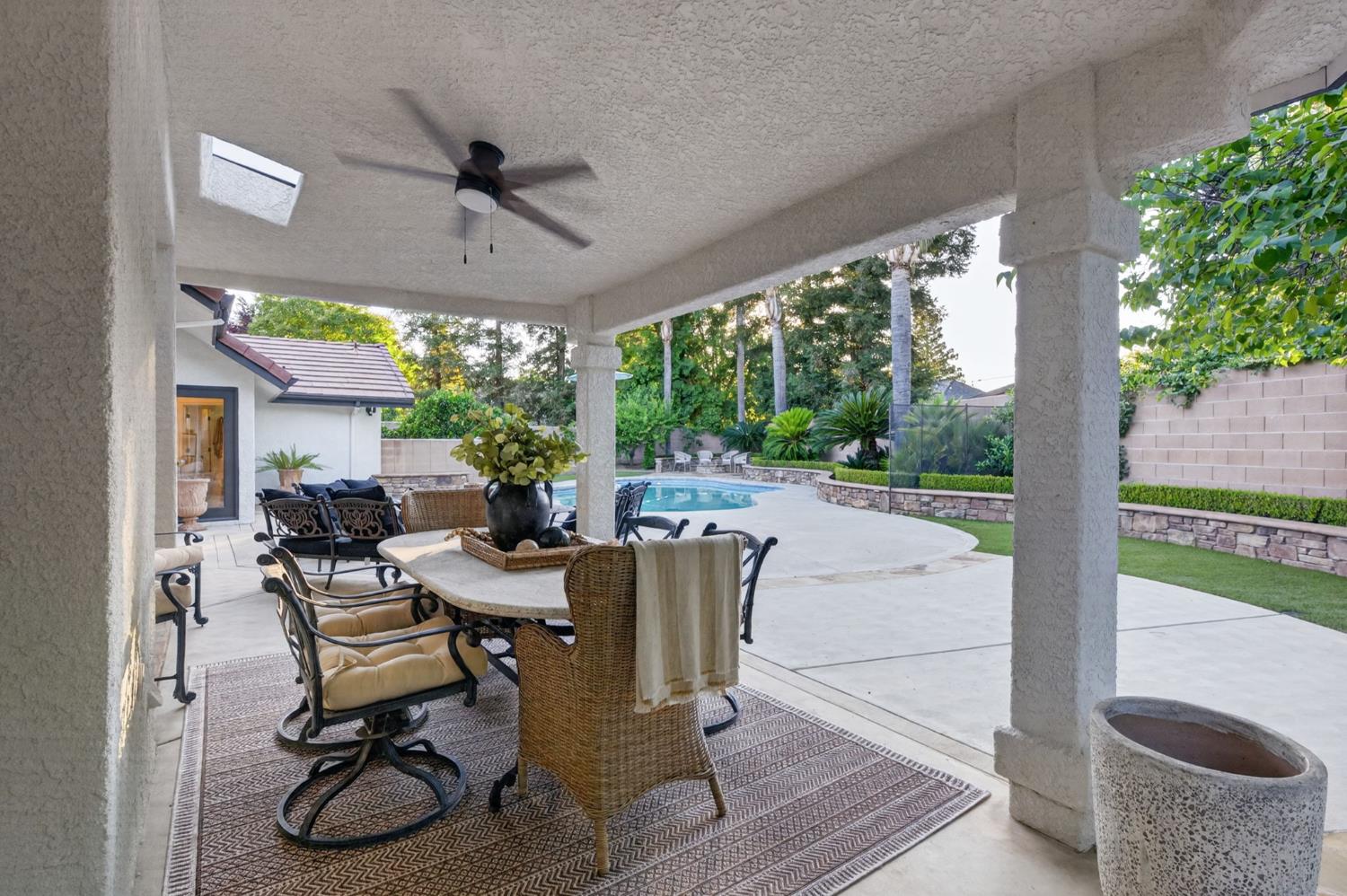 601 Decatur Avenue Clovis, CA 93611 - Photo 50 of 62 a view of a patio with table and chairs potted plants with wooden floor