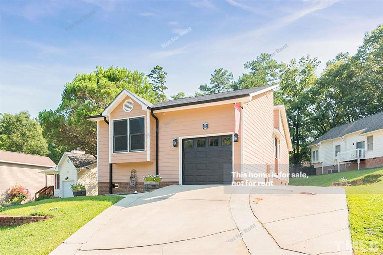 2412 Calvert Drive Raleigh, NC 27610 - Photo 1 of 19 a front view of a house with a yard and garage