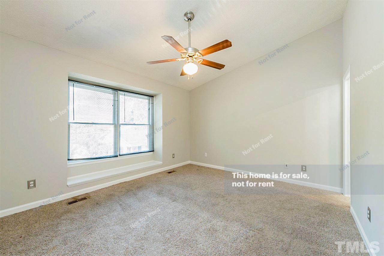 2412 Calvert Drive Raleigh, NC 27610 - Photo 12 of 19 an empty room with windows and fan