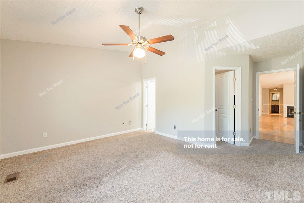 2412 Calvert Drive Raleigh, NC 27610 - Photo 13 of 19 an empty room with a ceiling fan and a window