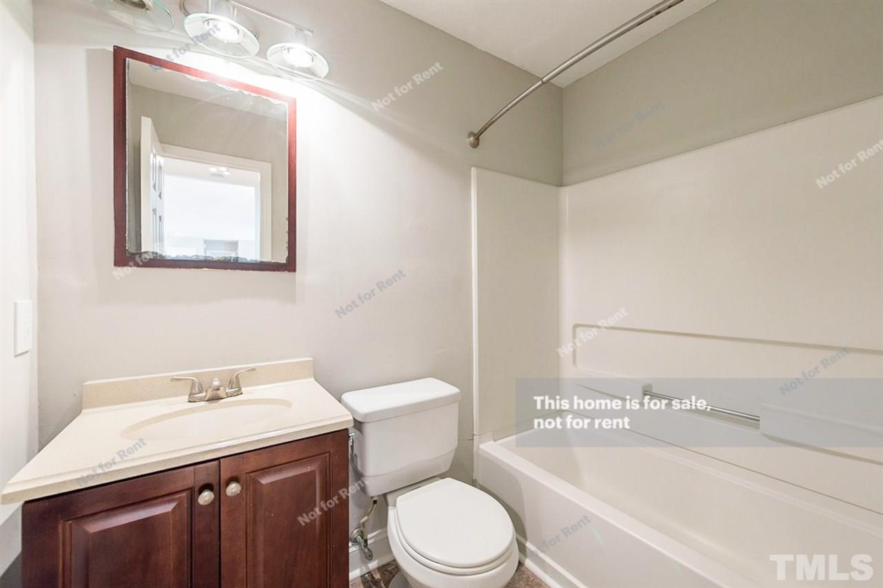 2412 Calvert Drive Raleigh, NC 27610 - Photo 16 of 19 a bathroom with a sink a toilet and shower