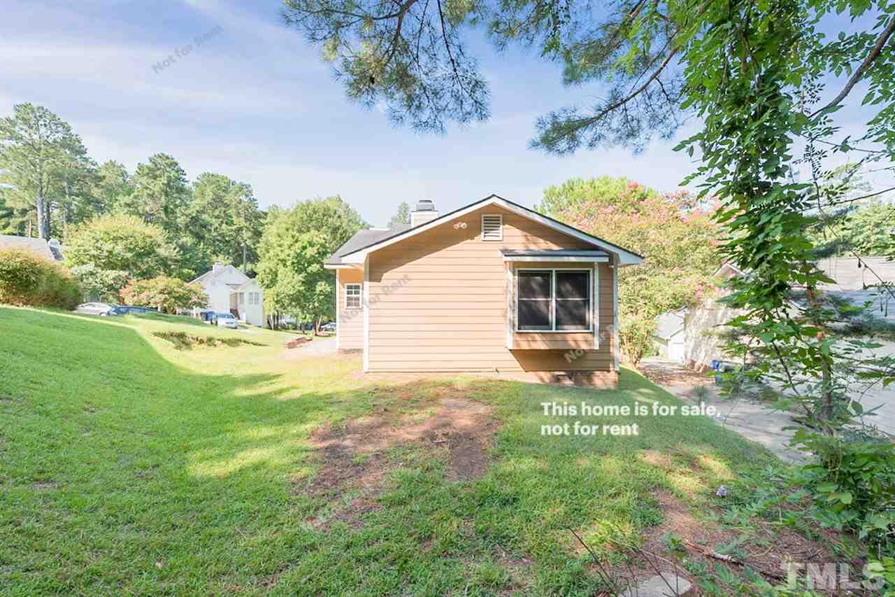 2412 Calvert Drive Raleigh, NC 27610 - Photo 5 of 19 a backyard of a house with table and chairs