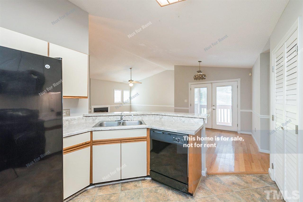 2412 Calvert Drive Raleigh, NC 27610 - Photo 6 of 19 a kitchen with a sink stove and cabinets