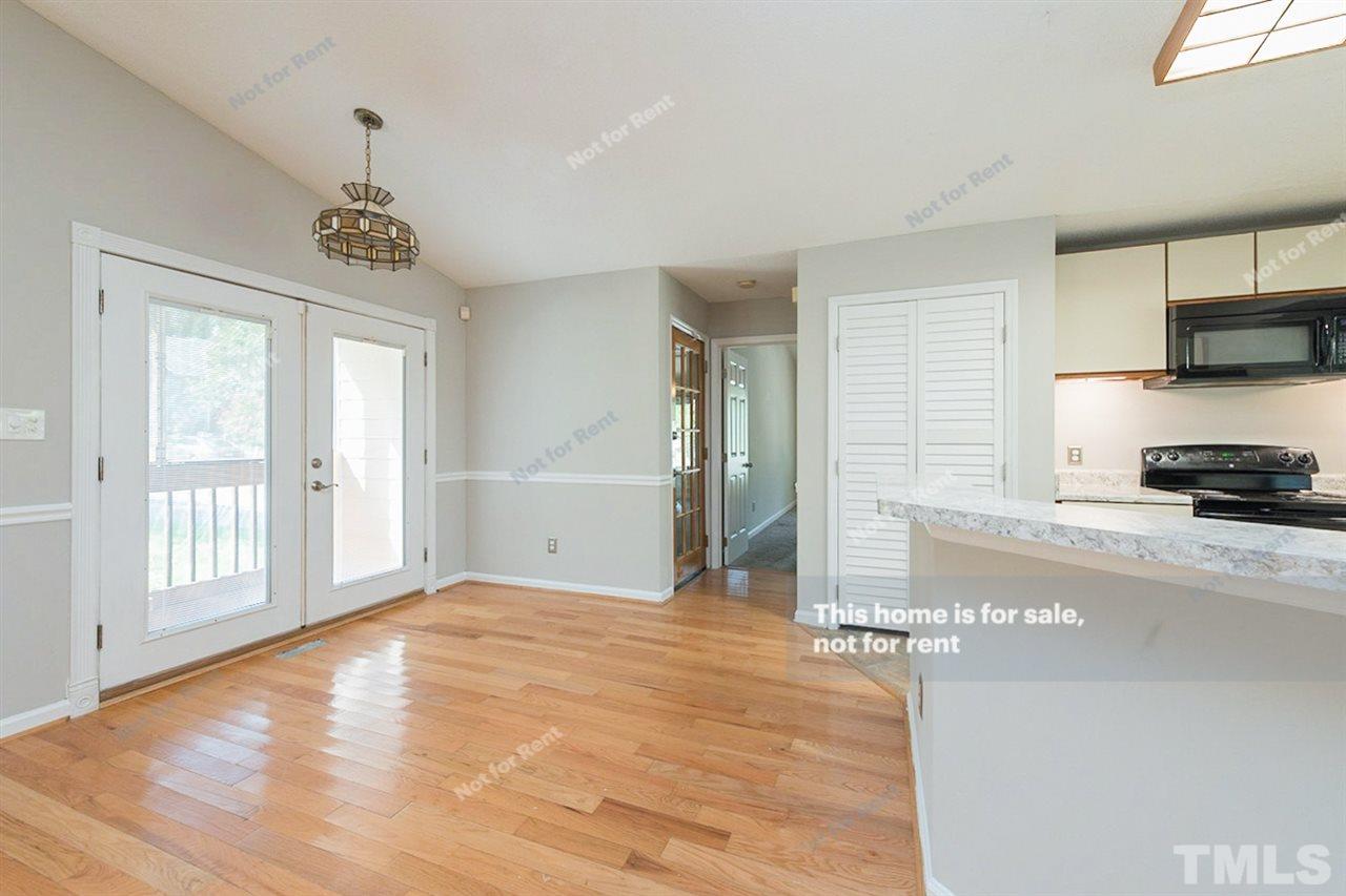 2412 Calvert Drive Raleigh, NC 27610 - Photo 7 of 19 a view of a kitchen with a stove cabinets and wooden floor