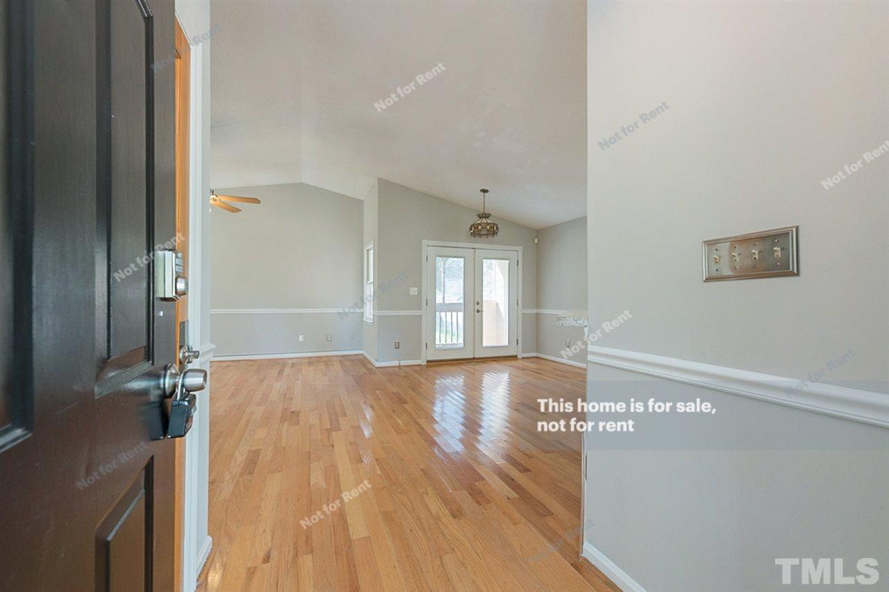 2412 Calvert Drive Raleigh, NC 27610 - Photo 8 of 19 a view of an empty room with wooden floor and a window