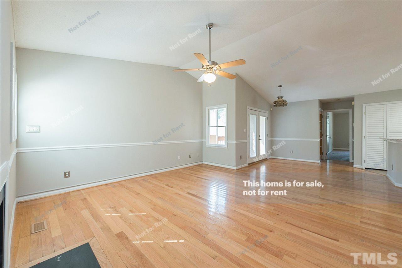2412 Calvert Drive Raleigh, NC 27610 - Photo 9 of 19 a view of an empty room with window and wooden floor