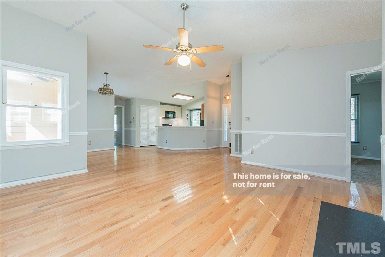 2412 Calvert Drive Raleigh, NC 27610 - Photo 10 of 19 a view of a room with wooden floor and staircase
