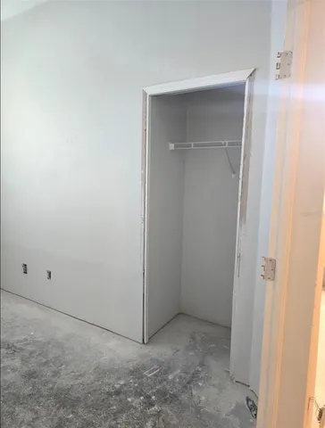 an empty room with a empty space and windows