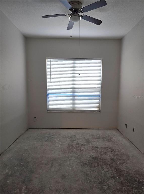 8640 Hawbuck Street Trinity, FL 34655 - Photo 19 of 33 an empty room with a empty space and windows