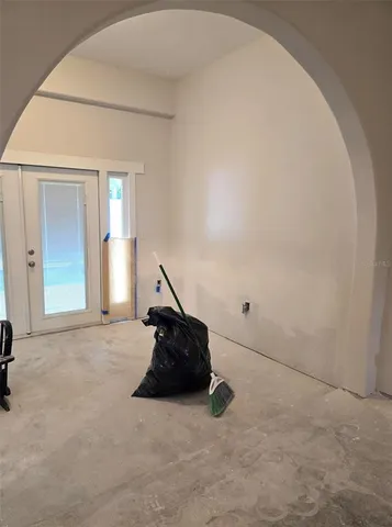 a living room with a couch and a chandelier