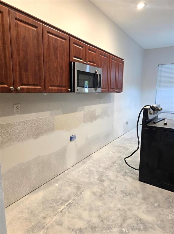 8640 Hawbuck Street Trinity, FL 34655 - Photo 9 of 33 a kitchen with granite countertop a cabinets and a stove top oven